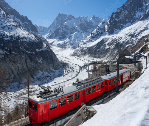 Montenvers train (cogwheel train) with Les Grandes Jorasses peaks and Mer de Glace glacier. View of Vallee Blanche (winter ski resort) of the Mont Blanc massif, Alps, Haute-Savoie, France photo