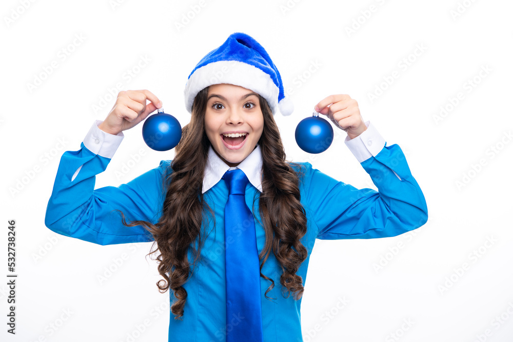 Portrait a smiling teen girl with blue santa hat, shirt and necktie hold christmas ball bauble isolated on white background. Merry Christmas sale, New Year celebration concept.