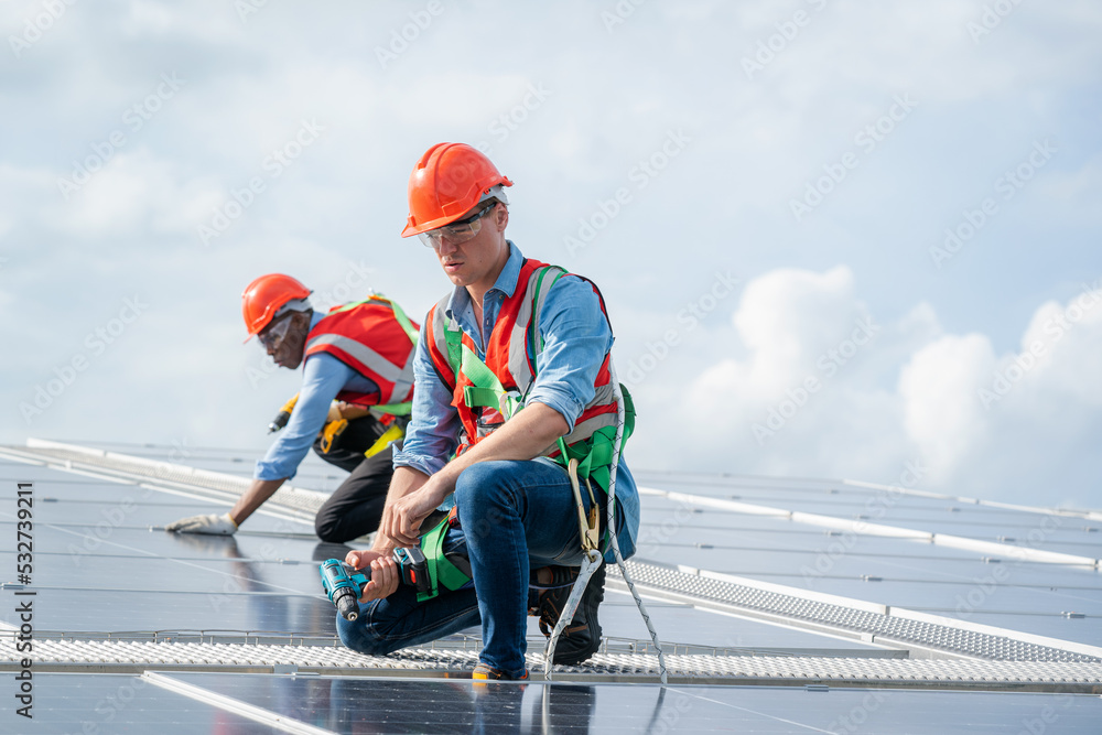 Engineers checking the operation of the system solar cell on roof at factory,Alternative energy to conserve the world's energy,Photovoltaic module idea for clean energy production. Engineers checking the operation of the system solar cell on roof at factory,Alternative energy to conserve the world's energy,Photovoltaic module idea for clean energy production.