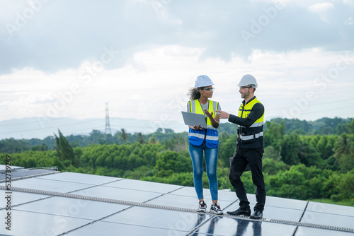 Installing solar cell on a roof Engineer working at solar power station.