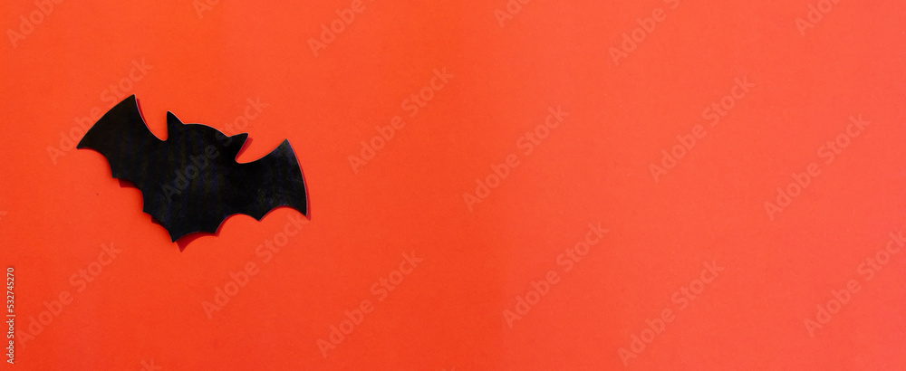 Fototapeta premium close up top view on paper style of flying bats on dark orange color background for halloween festival design concept