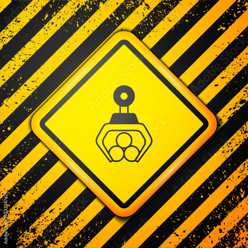 Black Grapple crane grabbed a log icon isolated on yellow background. Forest industry. Industrial crane for lumber trunk wood production. Warning sign. Vector