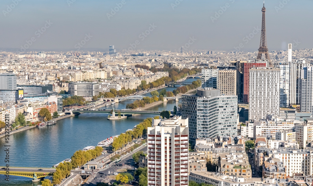 Aerial view of Paris city with the Eiffel tower and the Seine river, the Sacred Heart cathedral and white buildings. From a hot air balloon Ballon Generali in Parc André-Citroën park, 2 Rue Cauchy.