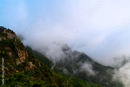 Clouded view of a stone mountain © Jinchoiphotography