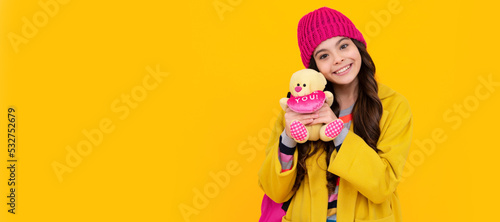 Winter school. Funny school girl with toy. Happy childhood and kids education. Banner of child girl with toy, studio portrait, header with copy space.