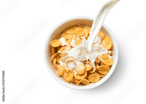 Top view of Pouring milk into the bowl of corn flakes isolated on white background. photo