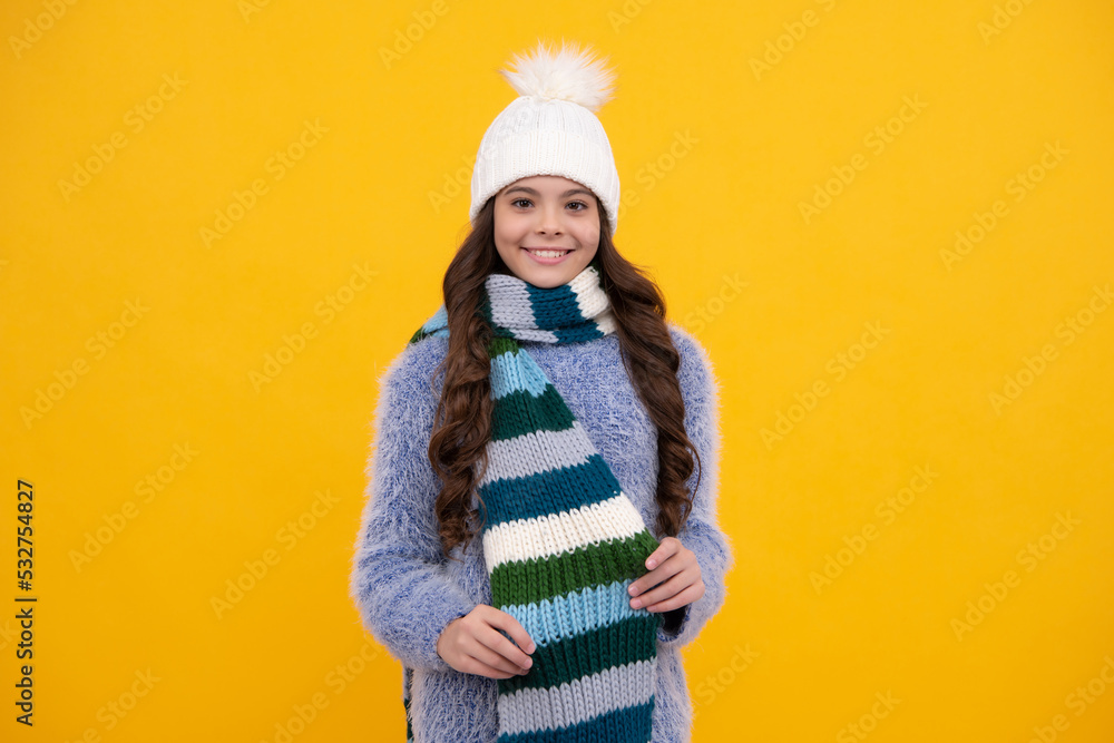 Teenager girl with winter hat over isolated yellow background. Winter christmas holidays, new year mood. Kids warm clothes. Happy girl face, positive and smiling emotions. Teenager girl with winter hat over isolated yellow background. Winter christmas holidays, new year mood. Kids warm clothes. Happy girl face, positive and smiling emotions.