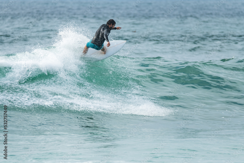 Local surfer riding waves