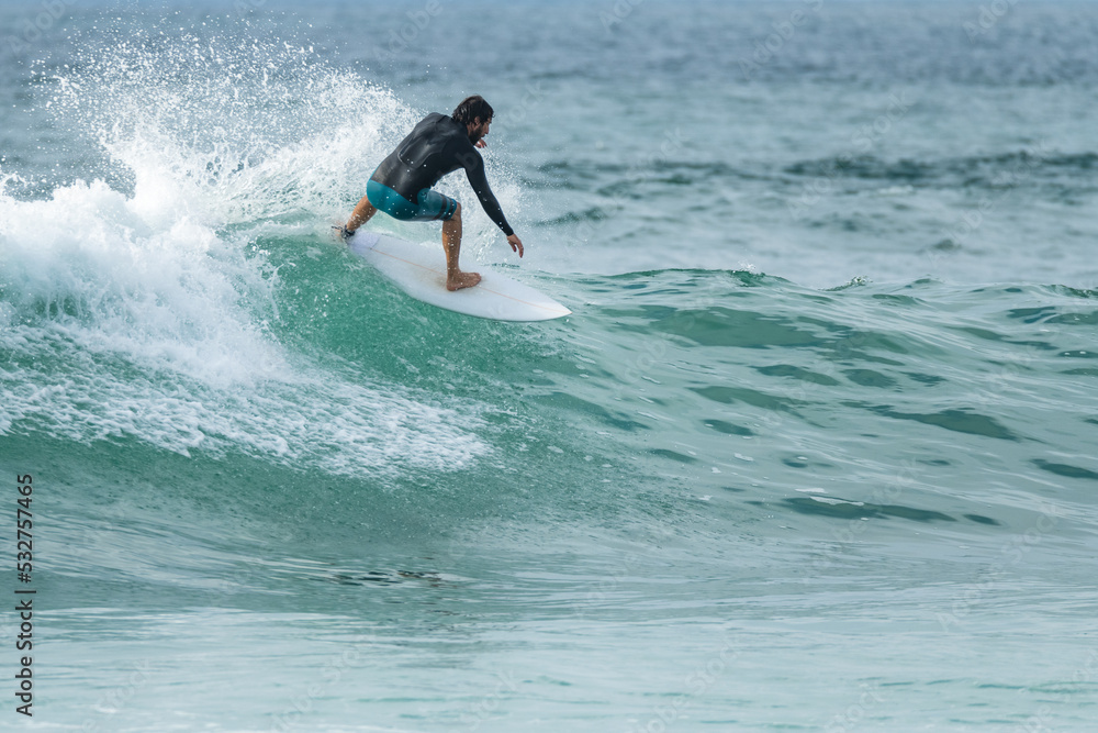 Local surfer riding waves