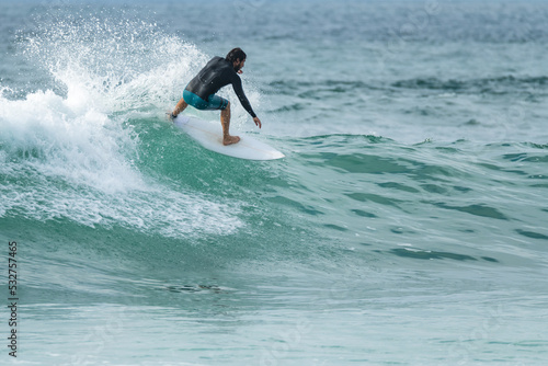 Local surfer riding waves © homydesign