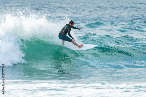 Local surfer riding waves © homydesign