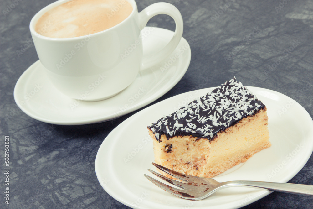 Fresh baked cheesecake and cup of coffee with milk. Delicious dessert Fresh baked cheesecake and cup of coffee with milk. Delicious dessert
