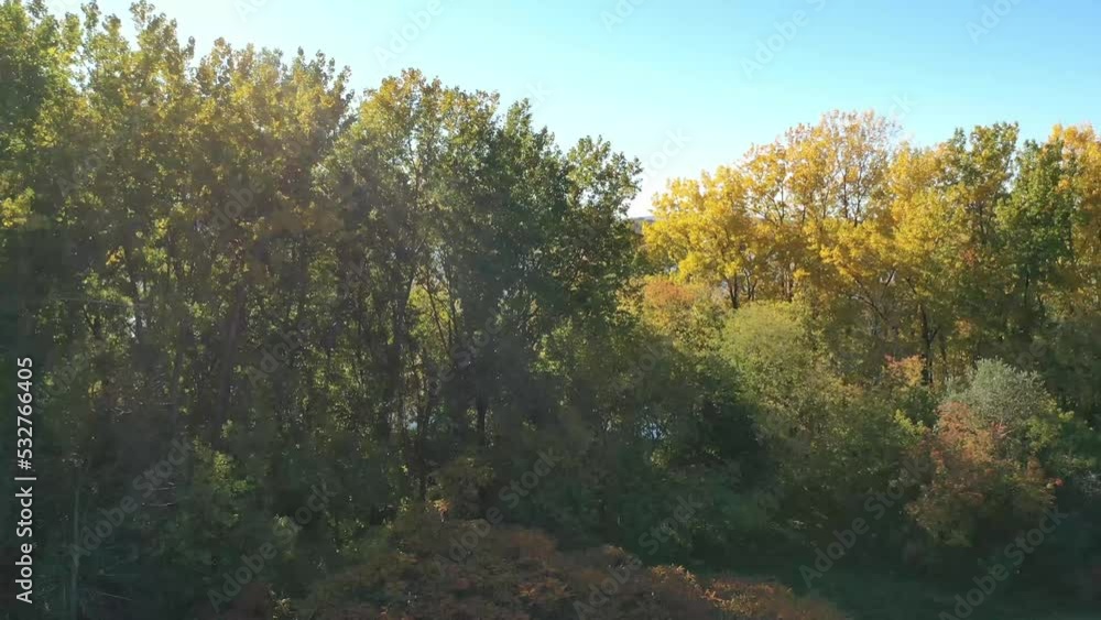Drone crane shot rising way above the colorful trees revealing the Milles Iles river between Laval-Ouest and St-Eustache Drone crane shot rising way above the colorful trees revealing the Milles Iles river between Laval-Ouest and St-Eustache