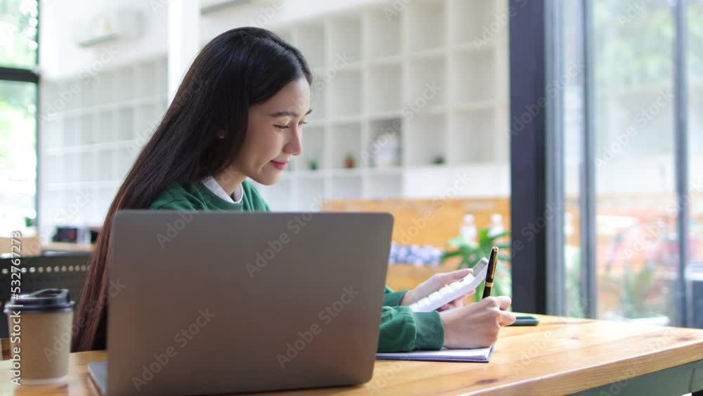 Woman working in finance is doing accounting calculations using a modern calculator and laptop. Woman working in finance is doing accounting calculations using a modern calculator and laptop.