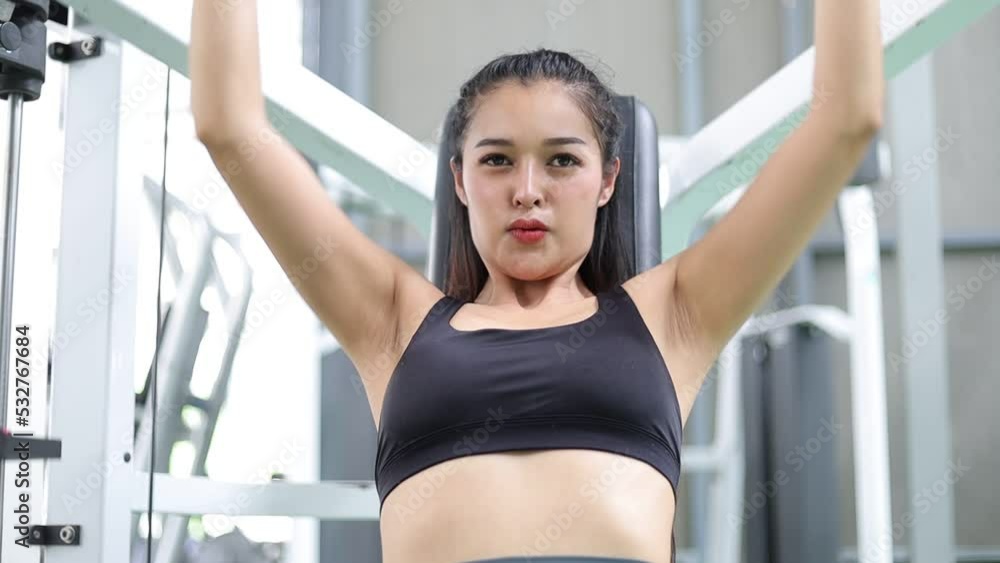 Woman exercising on multistation using weight lifting machine, at gym for arm and shoulders muscles. Fitness exercising in gym, sculpt muscles, bodybuilding. Woman exercising on multistation using weight lifting machine, at gym for arm and shoulders muscles. Fitness exercising in gym, sculpt muscles, bodybuilding.