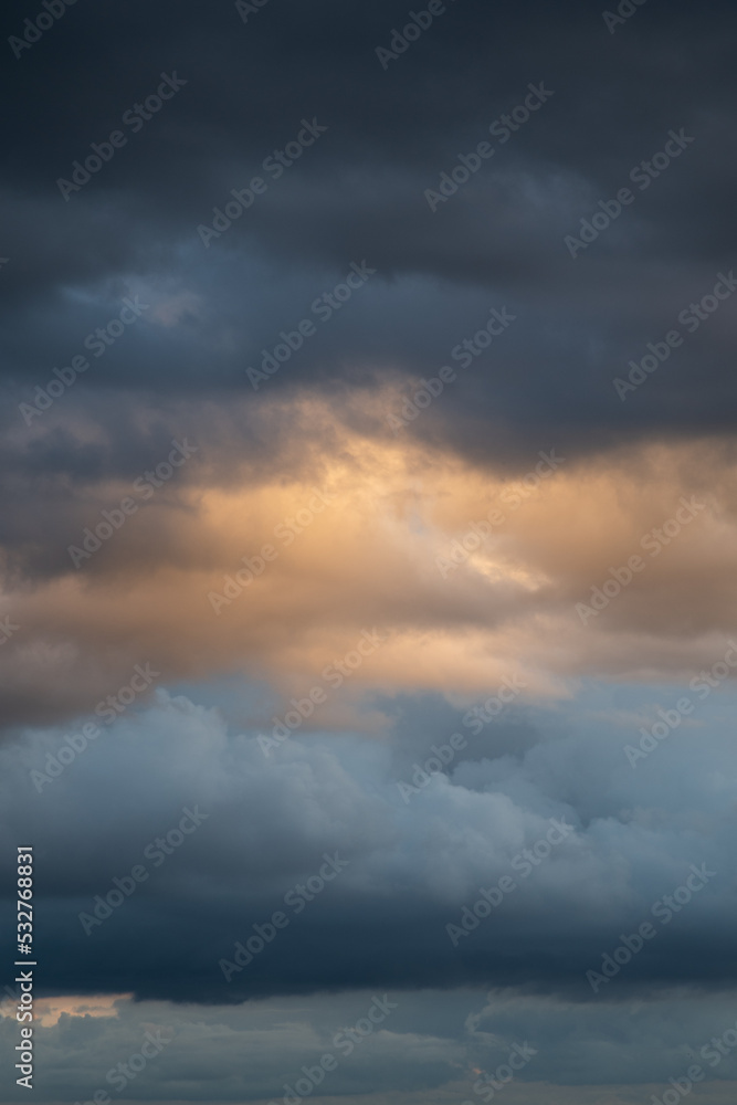 Naklejka premium Clouds before a thunderstorm, yellow-blue clouds. Background image, state of mind.