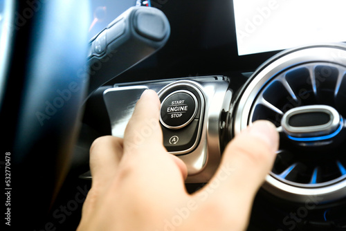 Εκτύπωση καμβά Close-up of anonymous finger's person pressing car's start botton engine ignition key, sitting in a modern and future car interior