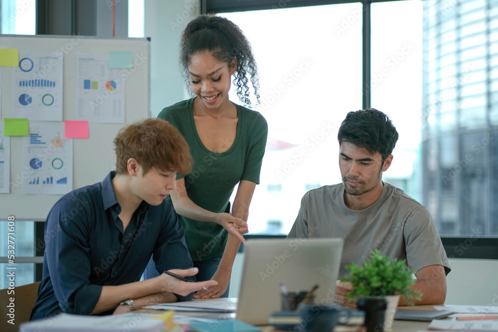 Group of young asian business people in smart casual wear working together in creative office using laptop. Group of young asian business people in smart casual wear working together in creative office using laptop.