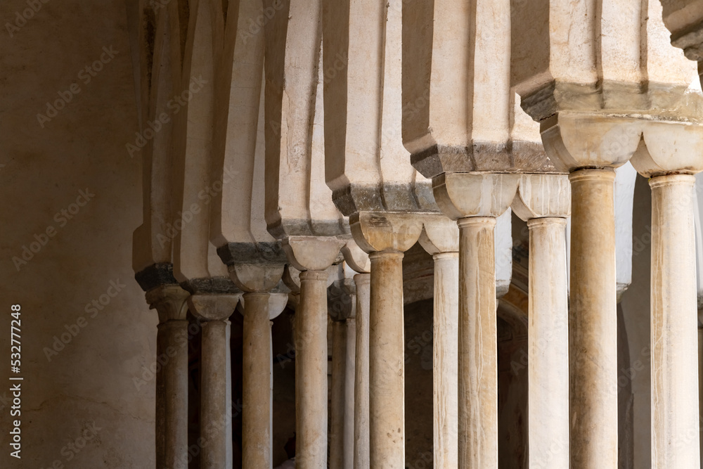 Columns and arches in the cloister of the “Cattedrale di Sant'Andrea“, the cathedral of Amalfi Italy and famous monument and tourist attraction. Light flashing in through the old historic arcades. Columns and arches in the cloister of the “Cattedrale di Sant'Andrea“, the cathedral of Amalfi Italy and famous monument and tourist attraction. Light flashing in through the old historic arcades.