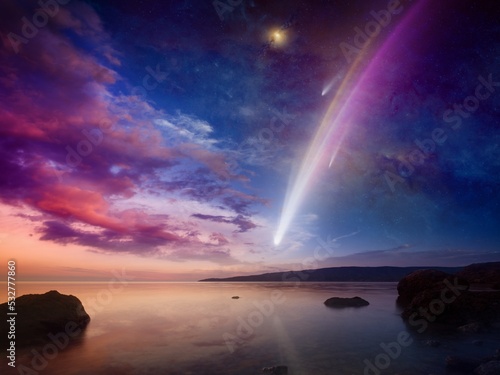 Amazing unreal picture: giant colorful comet in glowing sunset sky over calm sea. Comet is icy small Solar System body.