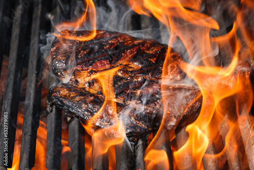 Quadro em tela Searing and smoking ribeye steaks on grill