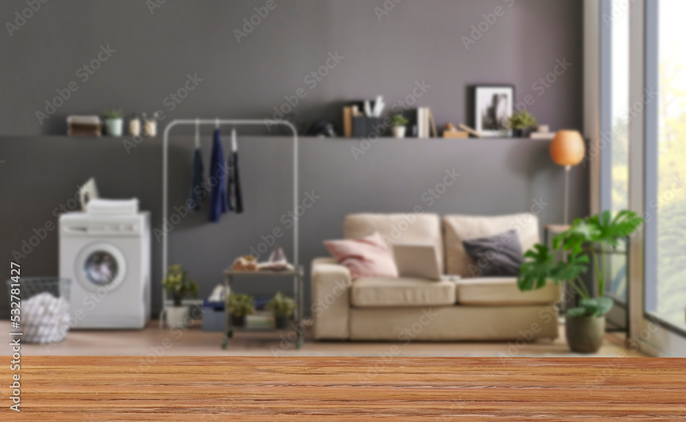 Fototapeta premium Wooden table close up and decorative grey room background style, blur detail.