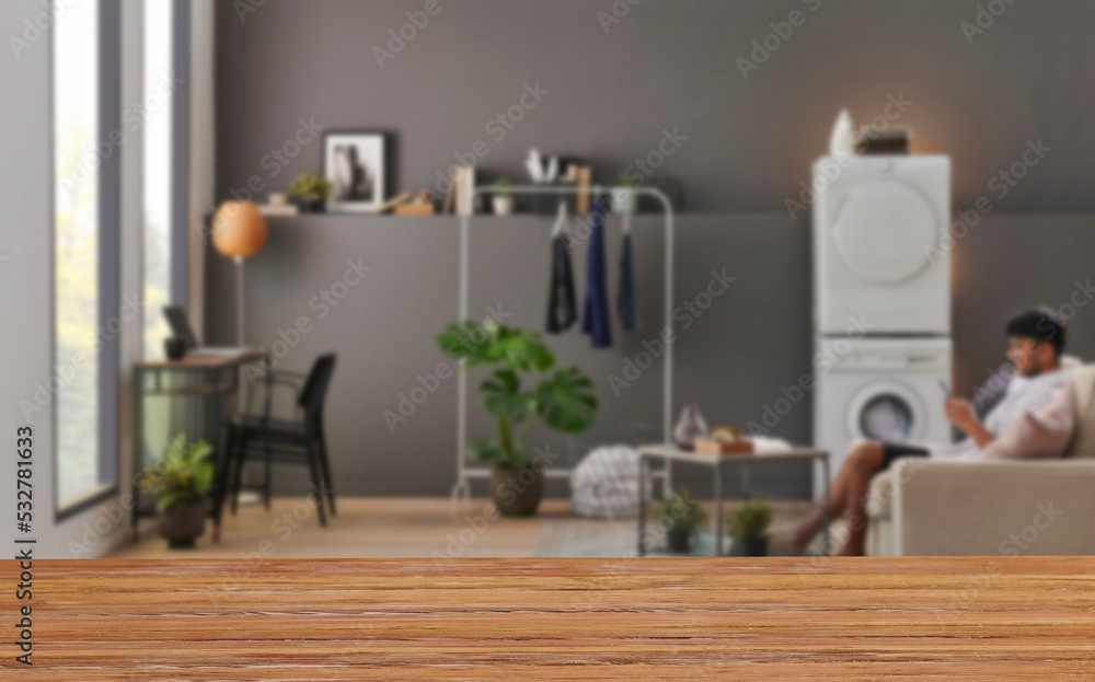 Wooden table close up and decorative grey room background style, blur detail. Wooden table close up and decorative grey room background style, blur detail.