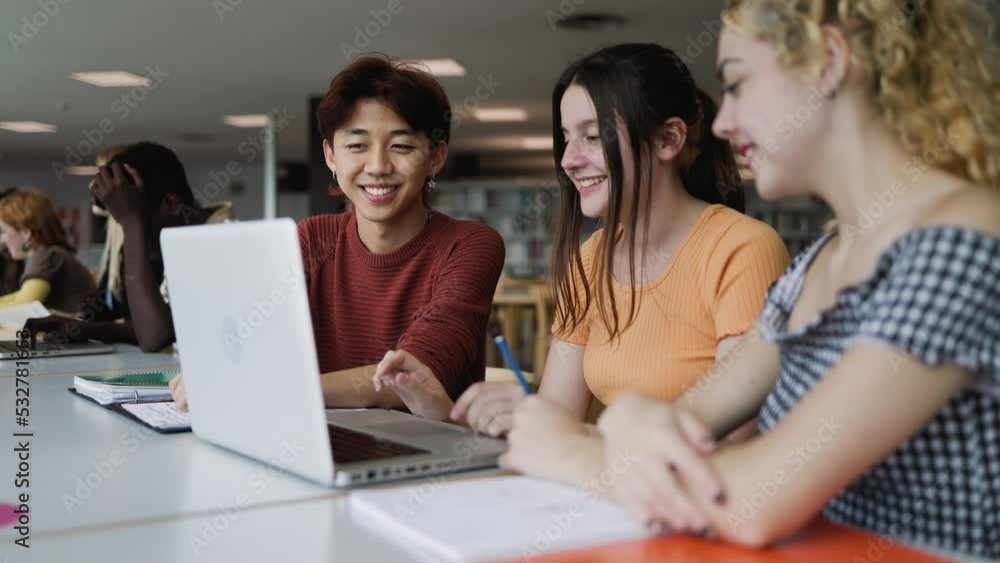 Young multiracial people studying together inside university library - School education concept Young multiracial people studying together inside university library - School education concept