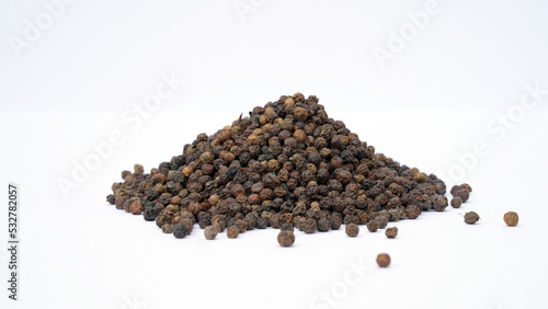 Pile of Organic Black pepper  Piper nigrum  isolated on white background. milled black pepper  Black pepper corns. Black pepper grains as background close up