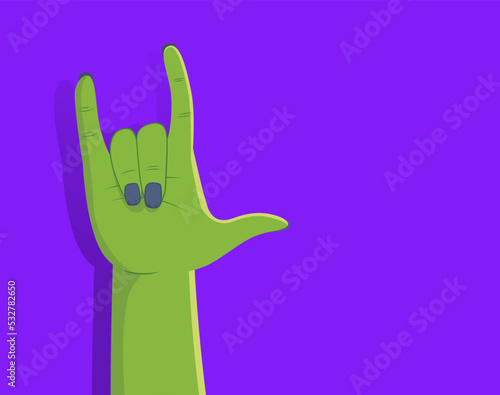 Zombie hand making rock gesture on purple background with right side copyspace. Person with green make up disguise for Halloween party