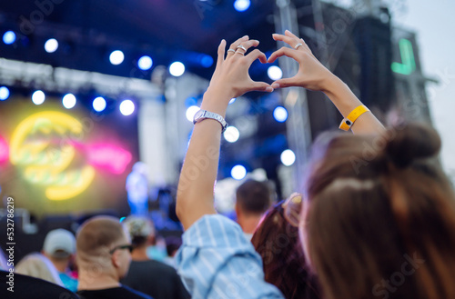 Using a smartphone in a public event, live music festival. Technologies, party, lifestyle.