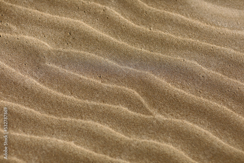 Wavy sand background for summer designs. Sand texture. Sandy beach for background. Top view. Natural sand stone texture background. sand on the beach as background. 