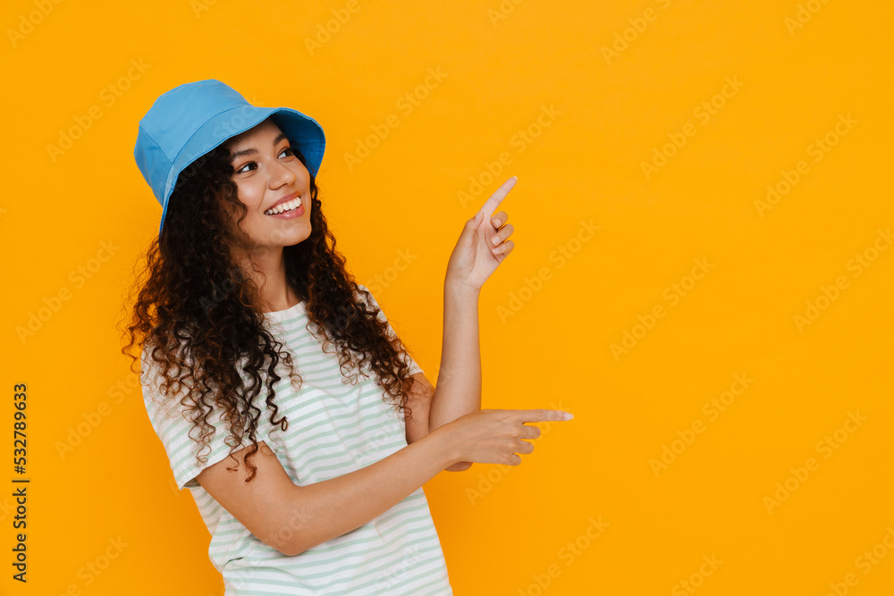 White curly woman expressing surprise and pointing fingers aside White curly woman expressing surprise and pointing fingers aside