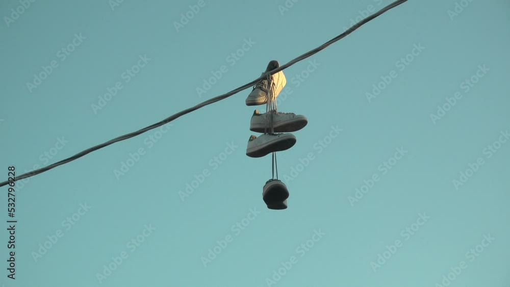Two pairs of shoes hanging from powerlines in Los Angeles Two pairs of shoes hanging from powerlines in Los Angeles
