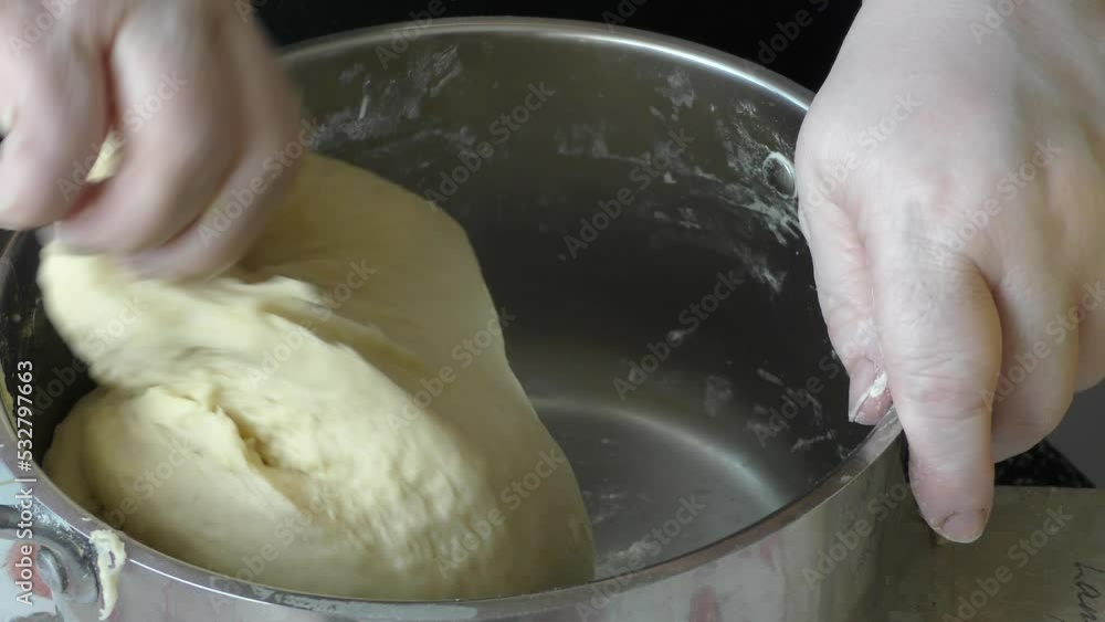 the cook kneads the dough for making pies with his hands the cook kneads the dough for making pies with his hands