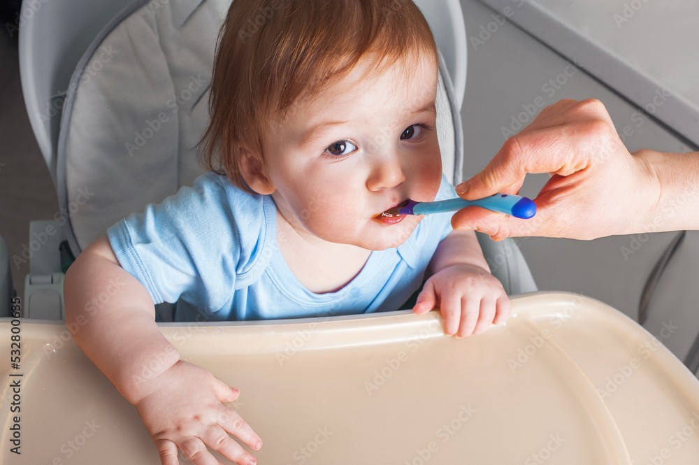 Baby in highchair covered in fruit, vegetable puree close-up. Complementary feeding tredhead oddler concept. Baby in highchair covered in fruit, vegetable puree close-up. Complementary feeding tredhead oddler concept.