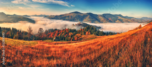 Majestic autumn rural scenery. Landscape with mountains  with morning fog © sergnester