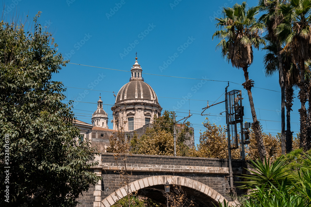 Bell tower of Catania baroque cathedral Saint Agata with blue sky in background