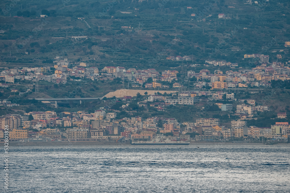 Beautiful view of old Messina harbor cityscape and the Mediterranean sea. Residential houses in ancient town of island. View of townscape at seacoast with waterfront.