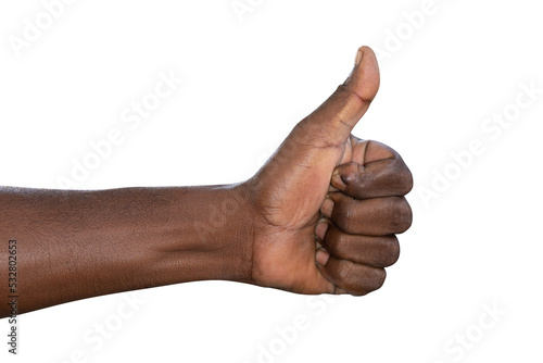 Closeup of male hand showing thumbs up sign against white background
