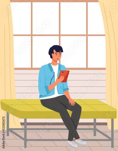 Man sitting on bench and uses tablet pc. Internet surfing or reading an article. Businessman chatting online at home. Social media, blogging. Male character talking via video call, recording podcast