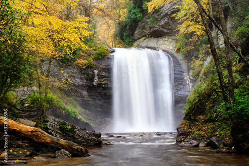 Looking Glass Falls waterfall in North Carolina surrounded by a beautiful autumn forest. 