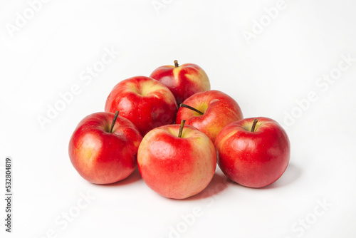 Organic red-yellow small apples on a white isolated background