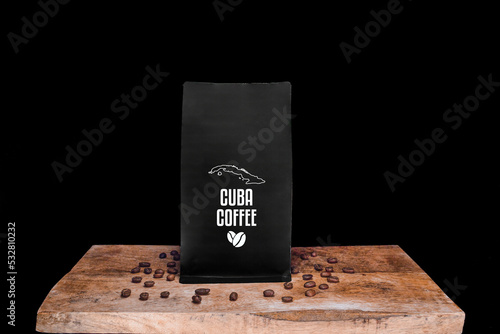 Cuba coffee beans and black package on wooden board with black isolated background