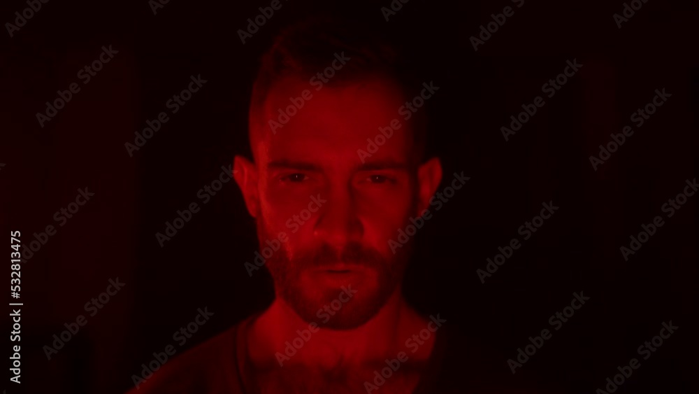 Angry man looking at camera with fury and rage, his face lit with fire flames of his personal hell, grief and sorrow. Male starring at viewer with aggresive emotions and insane devilish look. Angry man looking at camera with fury and rage, his face lit with fire flames of his personal hell, grief and sorrow. Male starring at viewer with aggresive emotions and insane devilish look.
