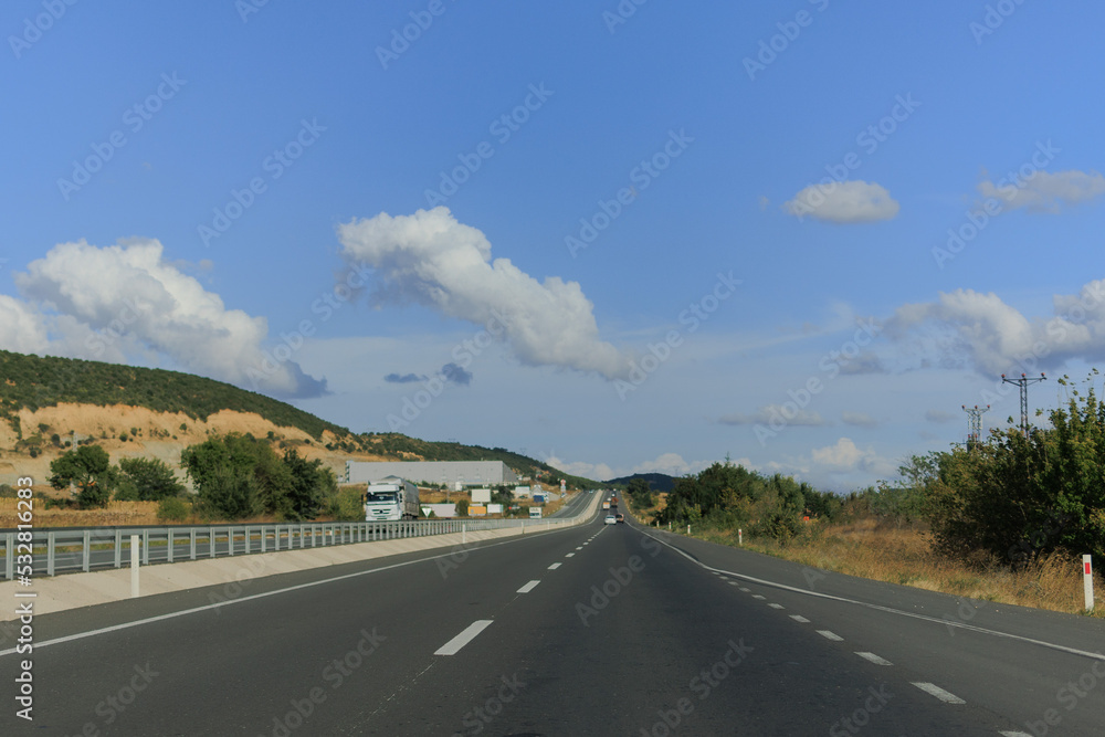 Highway wide road, transport and blue sky with clouds on a summer day Highway wide road, transport and blue sky with clouds on a summer day