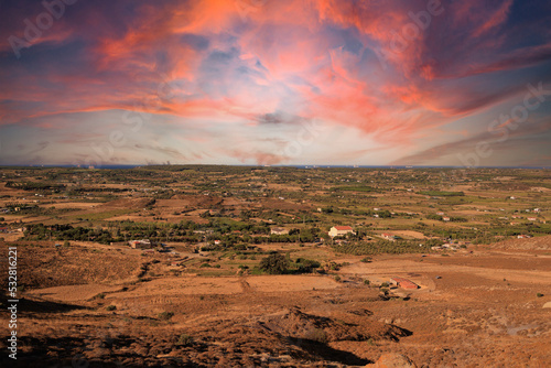 Evening landscape. Highway wide road, transport and orange sky with clouds on a summer day