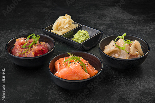 Japanese cuisine sashimi set on a dark stone background.