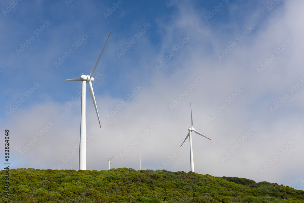 Electric turbine of a windmill with clouds Electric turbine of a windmill with clouds
