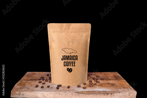 India coffee beans and eco friendly kraft paper package on wooden board with black isolated background
